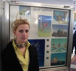 Nicoletta Ceccoli accanto ad un pannello della mostra contenente alcuni dei suoi lavori